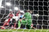PSG's goalkeeper Gianluigi Donnarumma, center, fails to stop a free kick by Arsenal's Bukayo Saka to concede a second goal during a Champions League opening phase soccer match between Arsenal FC and Paris Saint-Germain at Arsenal stadium in London, England, Tuesday, Oct. 1, 2024. (AP Photo/Alastair Grant)