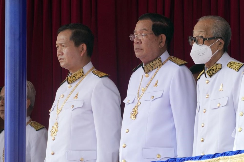 FILE - Cambodian Prime Minister Hun Manet, centre left, stands next to his father and former prime minister Hun Sen, center right, during the country's 70th Independence Day, in Phnom Penh, Cambodia, Thursday, Nov. 9, 2023. (AP Photo/Heng Sinith), File)
