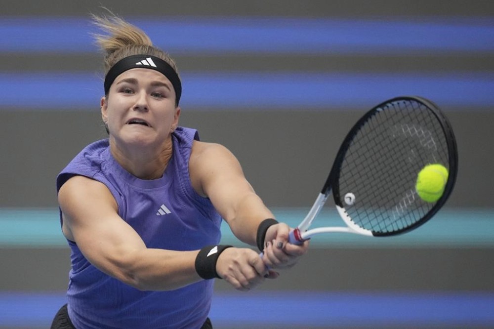 Karolina Muchova of the Czech Republic returns a shot to Aryna Sabalenka of Belarus during the women's singles quarterfinals match of the China Open tennis tournament, at the National Tennis Center in Beijing, Friday, Oct. 4, 2024. (AP Photo/Achmad Ibrahim)