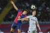 Young Boys' Cedric Itten, right, jumps for a header with Barcelona's Pau Cubarsi during the Champions League soccer match between Barcelona and Young Boys at the Lluis Companys Olympic Stadium in Barcelona, Spain, Tuesday, Oct. 1, 2024. (AP Photo/Joan Monfort)