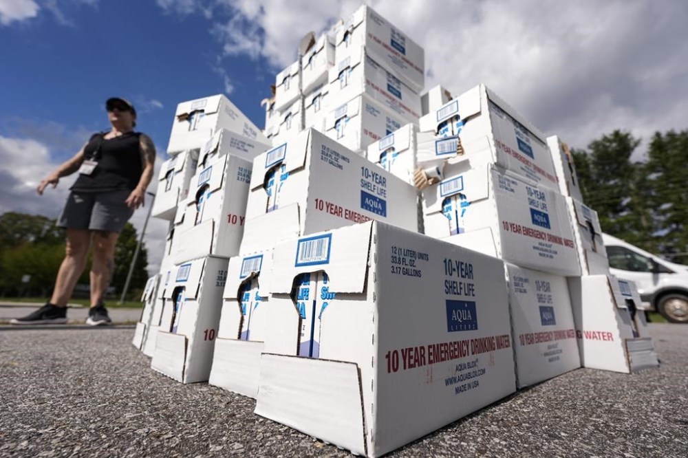 Volunteers stage water for citizens in the aftermath of Hurricane Helene, Monday, Sept. 30, 2024, in Asheville, N.C. (AP Photo/Mike Stewart)