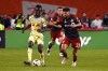 Toronto FC's Jonathan Osorio (21) vies for the ball against New York Red Bull's Ronald Donkor (48) during MLS action in Toronto on Wednesday, Oct. 2, 2024. Hanging on to the final playoff berth in the Eastern Conference, Toronto FC looks to pick up three more precious points in its regular-season finale against league-leading Miami at BMO Field on Saturday. THE CANADIAN PRESS/Jon Blacker