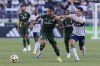 FILE - Portland Timbers midfielder Evander (10) an Vancouver Whitecaps midfielder Alessandro Schöpf (8) vie for the ball during an MLS soccer match, June 22, 2024, in Portland, Ore. (Sean Meagher/The Oregonian via AP, File)