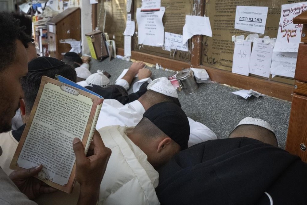 Orthodox Jews pray at the gravestone of Rabbi Nachman, the great grandson of the founder of Hasidic movement, to mark the Jewish new year in the town of Uman, 200 kilometers (125 miles) south of Ukraine's capital Kyiv, Ukraine, Thursday, Oct. 3, 2024. (AP Photo/Efrem Lukatsky)