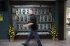 An attendee to the Humboldt Broncos Memorial service walks past a display at Elgar Petersen Arena in Humboldt , April, 6, 2019. THE CANADIAN PRESS/Kayle Neis