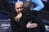 Manchester City's head coach Pep Guardiola, left, and Fulham's head coach Marco Silva embrace each other before the start of the English Premier League soccer match between Manchester City and Fulham at Etihad Stadium in Manchester, England, Saturday, Oct. 5, 2023. (AP Photo/Darren Staples)