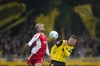 Union's Benedict Hollerbach, left, and Dortmund's Pascal Gross jump for the ball during the Bundesliga soccer match between Union Berlin and Borussia Dortmund in Berlin, Germany, on Saturday, Oct. 5, 2024.(AP Photo/Ebrahim Noroozi)