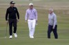 Louis Oosthuizen, left, Billy Horschel and Jay Monahan on the seventeenth green during day three of the Alfred Dunhill Links Championship at the Old Course St. Andrews, Scotland, Saturday Oct. 5, 2024. (Robert Perry/PA via AP)