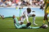 Lyon's Alexandre Lacazette, top, and Nantes' goalkeeper Alban Lafont fight for the ball during the French League One soccer match between Lyon and FC Nantes at the Groupama stadium in Decines, outside Lyon, France, Sunday, Oct. 6, 2024. (AP Photo/Laurent Cipriani)