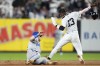 New York Yankees' Jazz Chisholm Jr. (13) slides safely into second base ahead of the tag from Kansas City Royals second baseman Michael Massey during the seventh inning of Game 1 of the American League baseball division series, Saturday, Oct. 5, 2024, in New York. (AP Photo/Frank Franklin II)