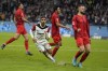 Frankfurt's Omar Marmoush, centre, celebrates after scoring his side's third goal during the German Bundesliga soccer match between Eintracht Frankfurt and Bayern Munich in Frankfurt, Germany, Sunday, Oct. 6, 2024. (AP Photo/Michael Probst)