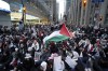 People hold a sit in on Bay St during a march for Gaza rally in support of Palestine in Toronto, on Saturday, Nov. 4, 2023. THE CANADIAN PRESS/Arlyn McAdorey