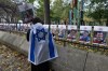 A woman looks at pictures of Israeli hostages during a pro-Israel vigil on the anniversary of a Hamas attack on Israel that triggered the ongoing war in Gaza in front of McGill University, in Montreal, Monday, Oct. 7, 2024. THE CANADIAN PRESS/Ryan Remiorz