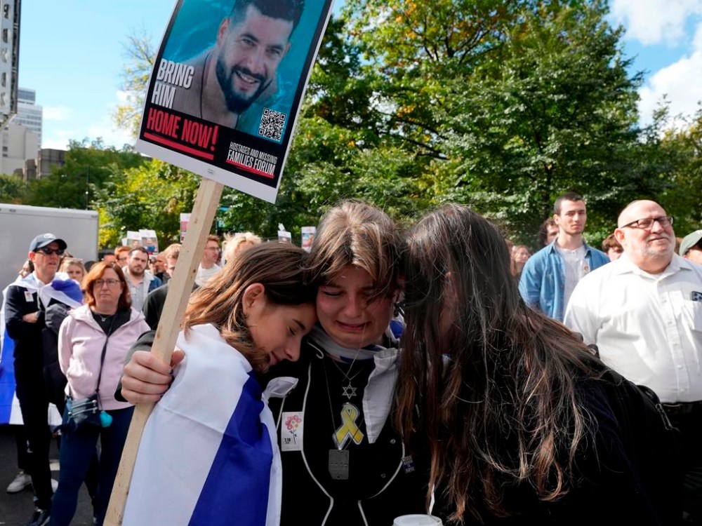 Attendees react during a pro-Israel vigil on the anniversary of a Hamas attack on Israel that triggered the ongoing war in Gaza in front of McGill University, in Montreal, Monday, Oct. 7, 2024. THE CANADIAN PRESS/Ryan Remiorz