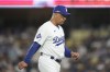 Los Angeles Dodgers manager Dave Roberts walks back to the dugout after making a pitching change during the seventh inning in Game 2 of a baseball NL Division Series against the San Diego Padres, Sunday, Oct. 6, 2024, in Los Angeles. (AP Photo/Ashley Landis)