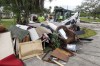 Contractors with the City of New Port Richey help clean debris left by Hurricane Helene in preparation for Hurricane Milton on Monday, Oct. 7, 2024, in New Port Richey, Fla. (AP Photo/Mike Carlson)