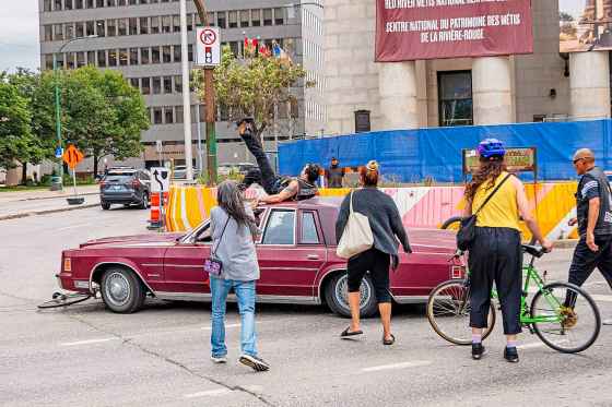 A man drove his vehicle through the protest blocking traffic at Portage and Main on Wednesday. (Nic Adam / Free Press)