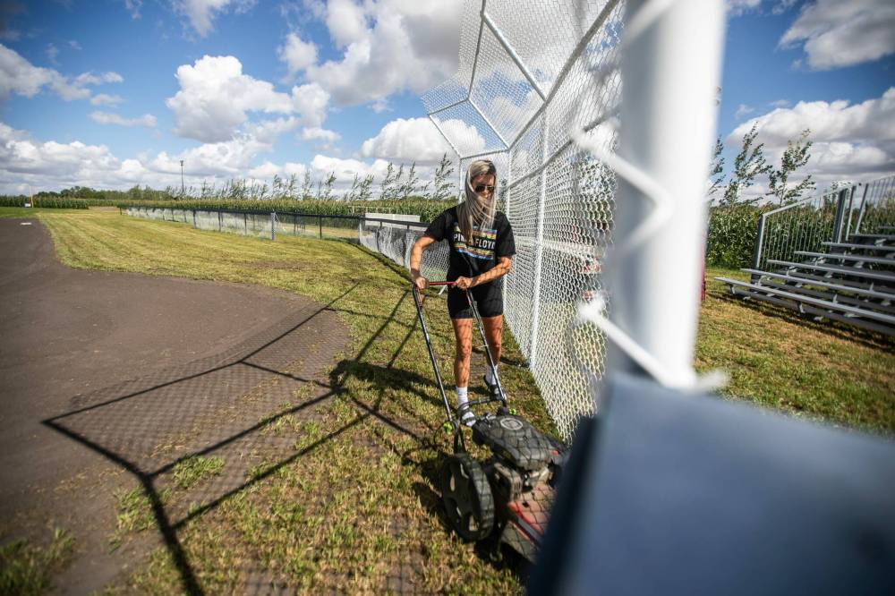 MIKAELA MACKENZIE / FREE PRESS
Claire McKay trims the grass at the edges of the Field of Dreams baseball diamond.