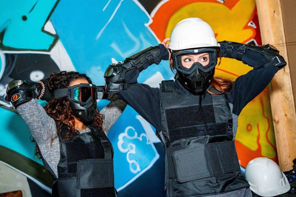 NIC ADAM / FREE PRESS
Kailey Faith (right) and Alejandra Hurtado, Unleashed Rage Rooms’ first two official customers, gear up in PPE before breaking stuff in the Jason (the shining) room.
