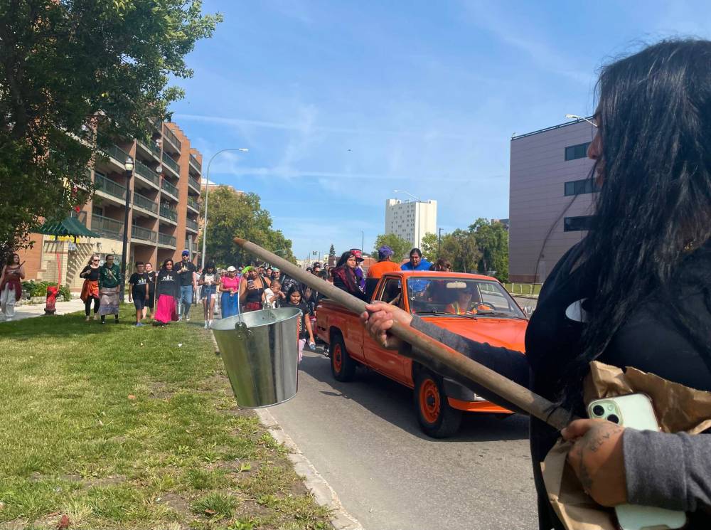 Maggie Macintosh / Free Press
Jasmine Brine, a coordinator at the Spence Neighbourhood Association, was among those who carried smudge buckets during the West End parade on Saturday.
