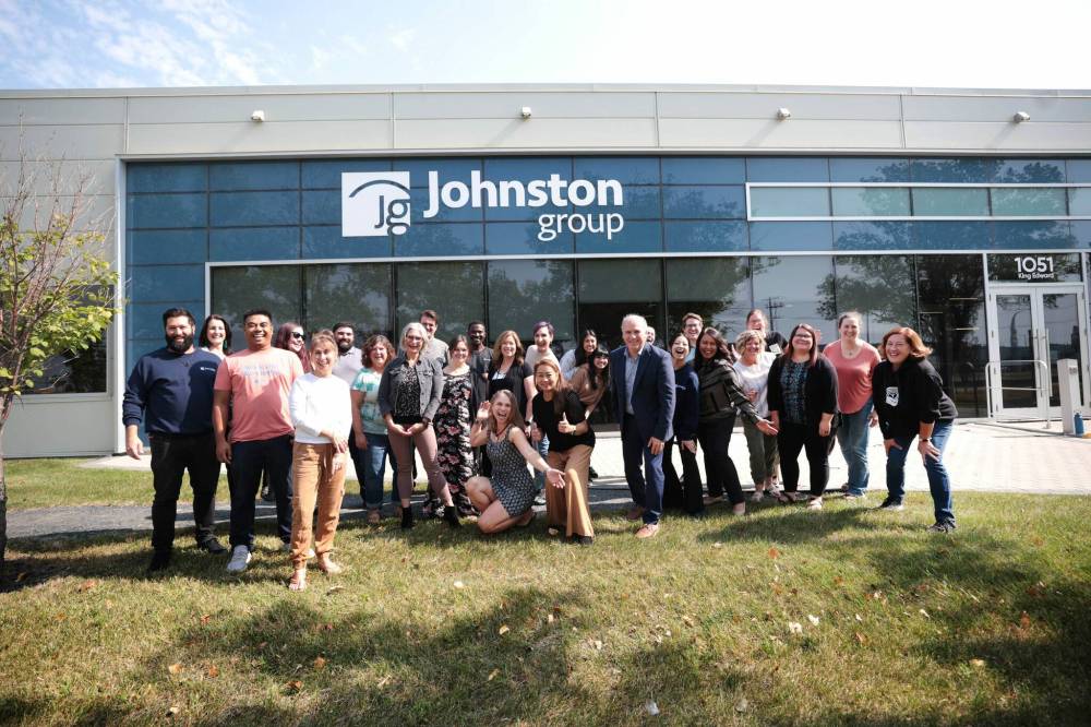 Ruth Bonneville / Free Press
Johnston Group staff outside the company’s Winnipeg headquarters, including president Dave Angus (blue suit, right of centre). Johnston Group is a family-owned business established in 1983.