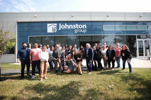 Ruth Bonneville / Free Press
                                Johnston Group staff outside the company’s Winnipeg headquarters, including president Dave Angus (blue suit, right of centre). Johnston Group is a family-owned business established in 1983.