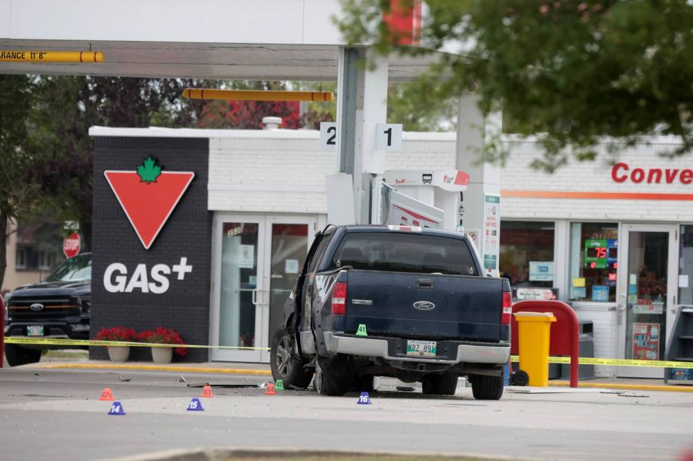 Ruth Bonneville / Free Press 
                                A blue truck heading eastbound on Portage Avenue near Bedson Street crashed into a bus shelter, then hit a telephone pole, a car, and finally a gas pump at a gas station early Friday morning. A person died at the scene.
