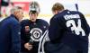 JOHN WOODS / THE CANADIAN PRESS
                                Winnipeg Jets goaltenders Eric Comrie (1) and Kaapo Kahkonen (34) talk to a coach during their NHL training camp practice in Winnipeg, Friday, September 20, 2024.