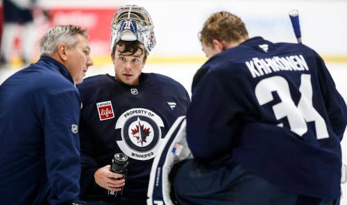 JOHN WOODS / THE CANADIAN PRESS
                                Winnipeg Jets goaltenders Eric Comrie (1) and Kaapo Kahkonen (34) talk to a coach during their NHL training camp practice in Winnipeg, Friday, September 20, 2024.