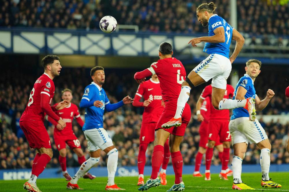 JON SUPER/ASSOCIATED PRESS FILES
Everton’s Dominic Calvert-Lewin (top), scores a spectacular goal during an English Premier League match against Liverpool.
