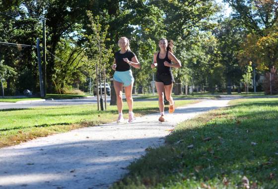 Joggers Camryn Watson (left) and her friend Tia Davidson decided to take advantage of the beautiful, summer-like weather and go for a five-kilometre run Thursday. (Ruth Bonneville / Free Press)