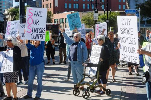 MIKE DEAL / FREE PRESS
                                A group of seniors rally outside City Hall chanting and waving signs to cars driving by on Main Street, to support Seniors Centres in Winnipeg and to draw attention to the fight for Good Neighbours Active Living Centre&rsquo;s building management rights Thursday morning.