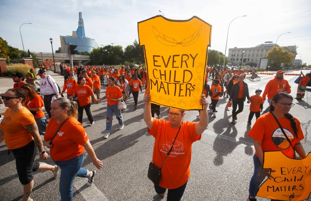 THE CANADIAN PRESS FILES
People march past the Canadian Museum for Human Rights during the second annual Orange Shirt Day walk in Winnipeg in 2022.
