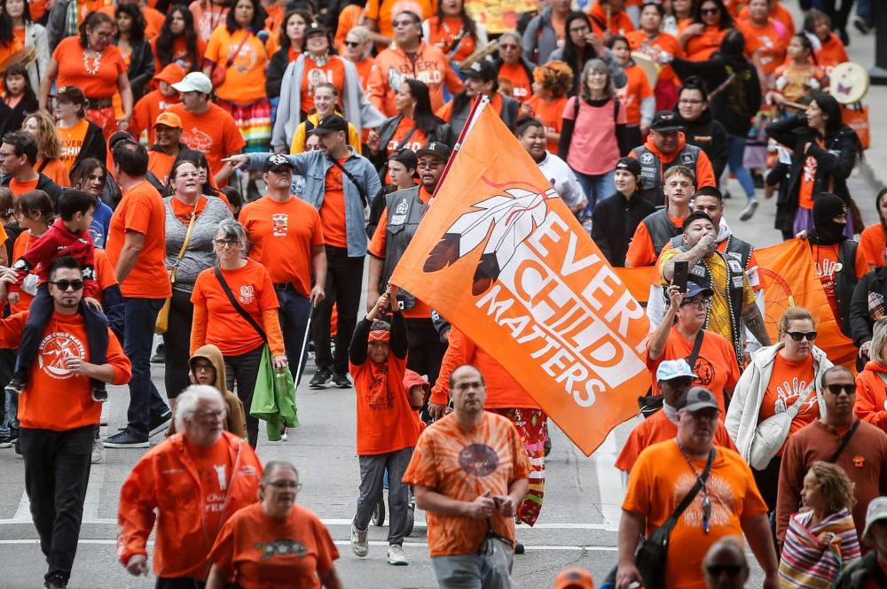 JOHN WOODS / FREE PRESS
People gather for Truth And Reconciliation Day, also known as Orange Shirt Day in Manitoba, as they walk down York Avenue in Winnipeg Monday.