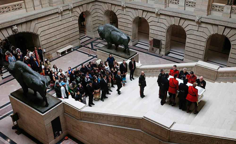 Family and friends escort the casket of Grand Chief Cathy Merrick for a ceremony and lying in state at the legislature in Winnipeg on Wednesday. (John Woods / The Canadian Press)