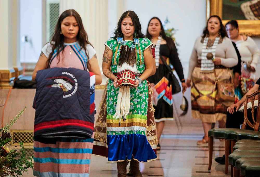 Belongings of Grand Chief Cathy Merrick are carried into a ceremony at the legislature in Winnipeg on Wednesday. (John Woods / The Canadian Press)