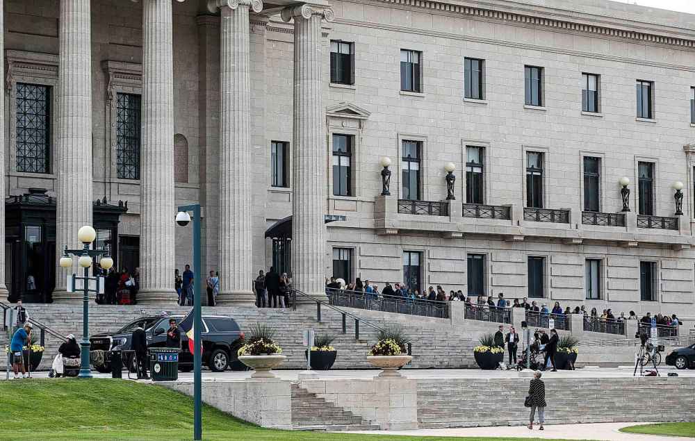 People lineup to sign a memorial book and to view the body of Grand Chief Cathy Merrick who is lying in state at the legislature in Winnipeg on Wednesday. (John Woods / The Canadian Press)