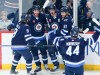 Winnipeg Jets' Alex Iafallo (9), Gabriel Vilardi (13), Mark Scheifele (55), Kyle Connor (81) and Josh Morrissey (44) celebrate ScheifeleÕs goal against the Florida Panthers during first period NHL action in Winnipeg on Saturday, October 14, 2023. THE CANADIAN PRESS/John Woods