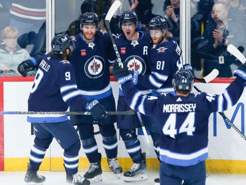 Winnipeg Jets' Alex Iafallo (9), Gabriel Vilardi (13), Mark Scheifele (55), Kyle Connor (81) and Josh Morrissey (44) celebrate ScheifeleÕs goal against the Florida Panthers during first period NHL action in Winnipeg on Saturday, October 14, 2023. THE CANADIAN PRESS/John Woods
