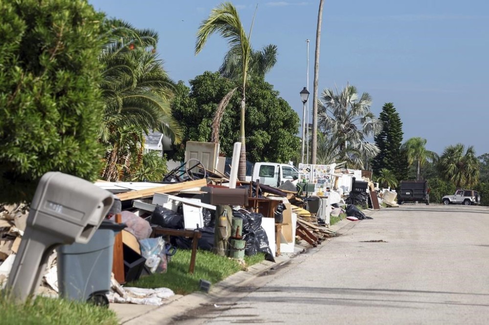 Debris from homes flooded in Hurricane Helene sits curbside as Hurricane Milton approaches on Tuesday, Oct. 8, 2024, in Port Richey, Fla. (AP Photo/Mike Carlson)
