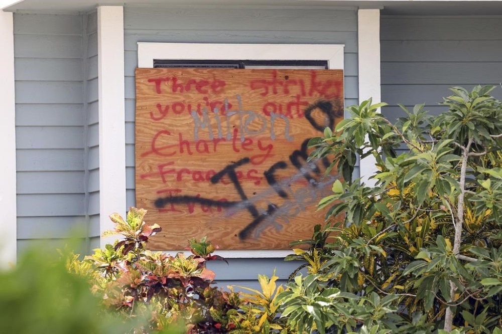A sign on a home lists hurricane names in preparation for Hurricane Milton on Tuesday, Oct. 8, 2024, in New Port Richey, Fla. (AP Photo/Mike Carlson)