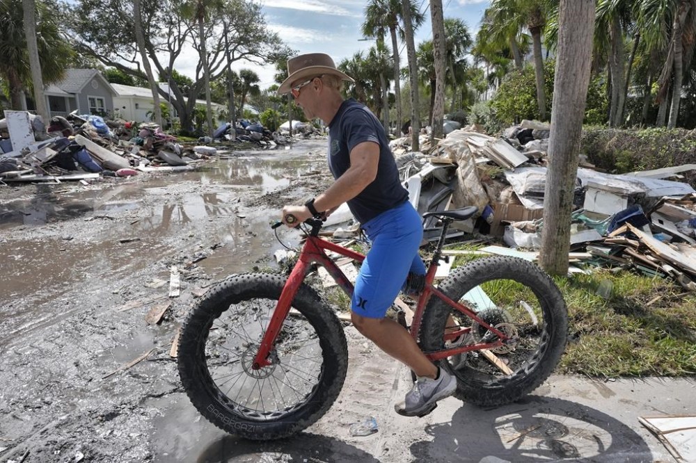 Arnie Bellini surveys the damages caused from Hurricane Helene on a street in Clearwater Beach, Fla., Tuesday, Oct. 8, 2024. Bellini fronted $500,000. of his own money to help speed up debris cleanup ahead of the possible arrival of Hurricane Milton. (AP Photo/Chris O'Meara)