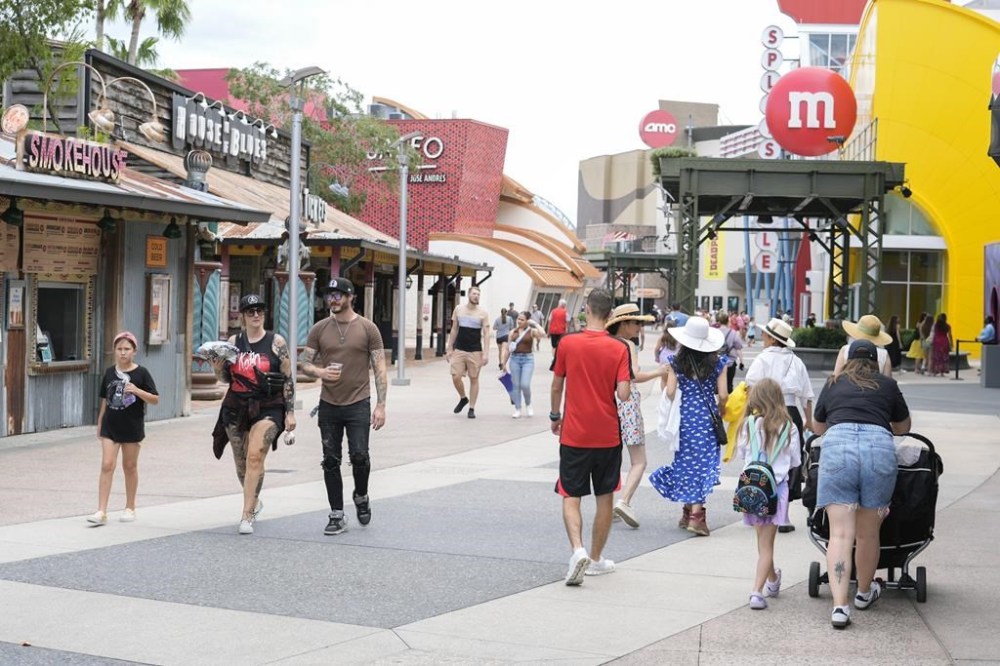 Calm weather greets tourists strolling past the various shops at the Disney Springs entertainment complex as Hurricane Milton threatens Florida, Tuesday, Oct. 8, 2024, in Lake Buena Vista, Fla. (AP Photo/John Raoux)