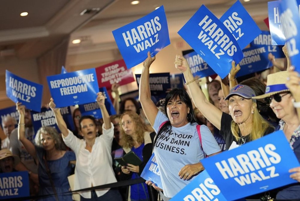 FILE - Supporters cheer as speakers arrive at an event kicking off a national