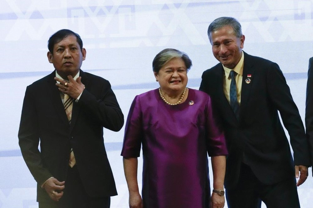 Myanmar's Foreign Secretary Aung Kyaw Moe, Philippine Foreign Undersecretary Theresa Lazaro, Singaporean Foreign Minister Vivian Balakrishnan, pose for a group photo at the Association of Southeast Asian Nations (ASEAN) Foreign Ministers' Meeting in Vientiane, Laos, Tuesday, Oct. 8, 2024. (AP Photo/Sakchai Lalit)
