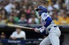 Los Angeles Dodgers' Mookie Betts watches his solo home run during the first inning in Game 3 of a baseball NL Division Series against the San Diego Padres, Tuesday, Oct. 8, 2024, in San Diego. (AP Photo/Gregory Bull)