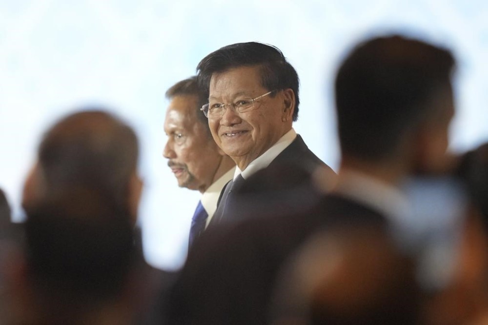Laos' President Thongloun Sisoulith, right, walks with Brunei Sultan Hassanal Bolkiah upon arrival to attend the opening ceremony of the Association of South East Asian Nations (ASEAN) Summit in Vientiane, Laos, Wednesday, Oct. 9, 2024. (AP Photo/Dita Alangkara)