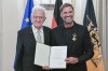Soccer coach Juergen Klopp, right, receives the Order of Merit of the German State of Baden-Wuerttemberg in Stuttgart, Germany, Tuesday, Oct. 8, 2024, from Governor Winfried Kretschmann, left, for his wide-ranging social commitment outside of sport. (Bernd Weissbrod/dpa via AP)