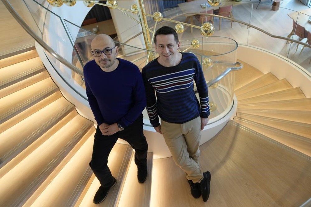 Researcher John Jumper, left, and Demis Hassabis, CEO of DeepMind Technologies, the AI division behind Gemini, speak to Associated Press at the Google DeepMind offices in London, Wednesday, Oct. 9, 2024 after being awarded with the Nobel Prize in Chemistry.(AP Photo/Alastair Grant)