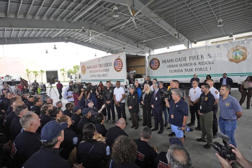 Miami-Dade County Mayor Daniella Levine Cava, center, addresses members of Miami-Dade Fire Rescue's Urban Search and Rescue Florida Task Force One before they deploy ahead of Hurricane Milton, Wednesday, Oct. 9, 2024, in Doral, Fla. (AP Photo/Wilfredo Lee)